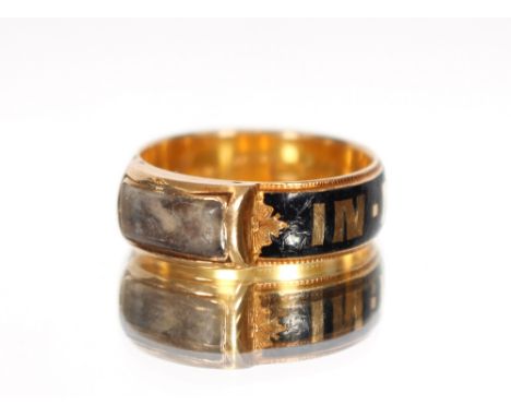 A 18ct gold and enamel mourning ring, with hair memento