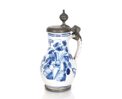 An 18th Century blue and white English Delftware baluster jug of small size, having pewter lid with finial thumbpiece, floral