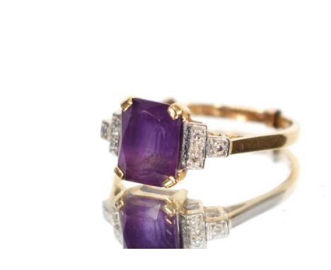 An 18ct gold ring with amethyst coloured stone and illusion set shoulders