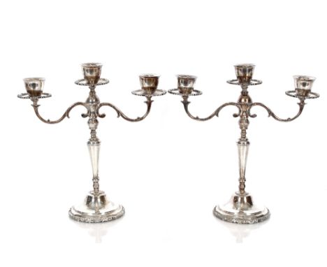 A pair of three light candelabra, scrolled arms above stepped bases with cast foliate surround, stamped Mexico Sterling 925, 