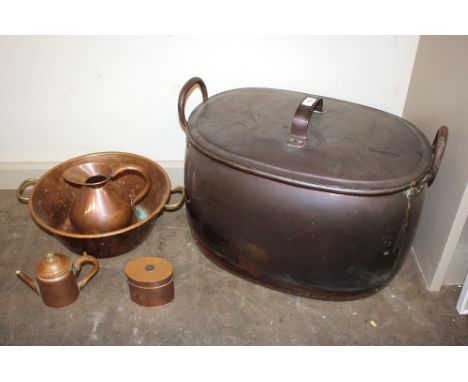 A large antique copper boiling pan with lid, flanked by iron loop handles, 58cm; a copper gallon measuring jug; a copper pres