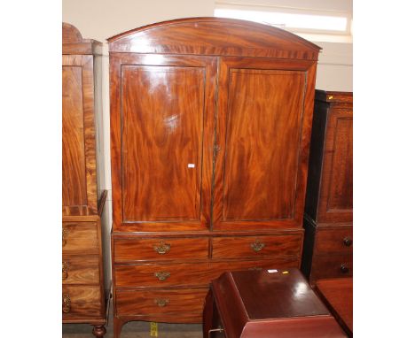 A Georgian mahogany linen press, the upper section fitted four sliding trays, the lower section fitted two short and two long