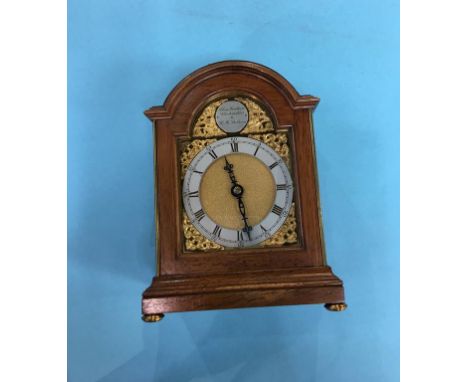 A reproduction walnut mantle clock