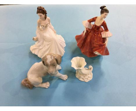 Two figures, a Nao dog, and a Royal Worcester shell