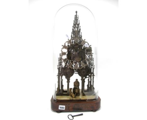 A Mid XIX Century Scott Memorial Skeleton Clock, the pierced brass frame in Gothic style, above the seated figure of Walter S