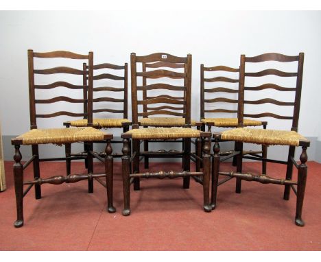 A Set of Six XIX Century Style Ash and Elm Ladder Back Chairs, with rushed seats, on turned legs united by stretchers. (6)