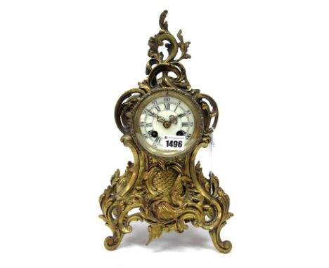 An Early XX Century Brass Cased Mantel Clock, the rococo style case with scrolls and foliage, upon four curved feet, the crea