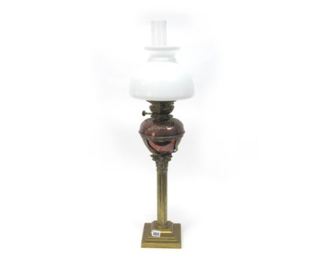 A Late XIX Century Brass Oil Lamp, the central Corinthian column supporting the copper circular reservoir with embossed flora
