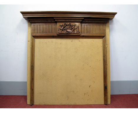 A XIX Century Pine Fireplace Surround, with dentil cornice above a central frieze of three cherubs holding hammers above an a
