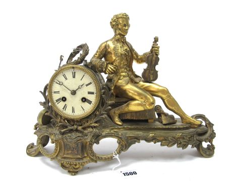 A Mid XIX Century Ormolu Cased Mantel Clock, the circular white enamel dial with Roman numerals, the elaborate shaped oval ba
