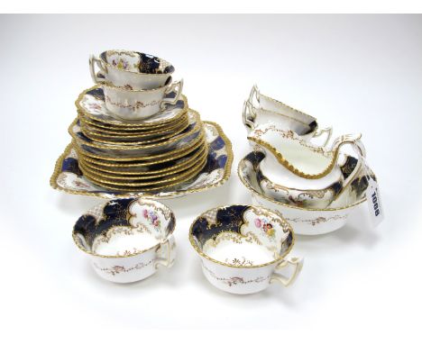 A Coalport Porcelain Part Tea Service, decorated in the 'Batwing' pattern of panels of floral sprays within dark blue and gil