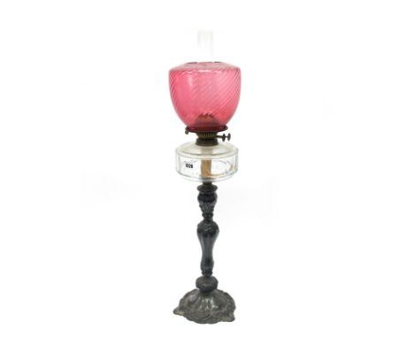 An Early XX Century Oil Lamp, the hallmarked silver base cast with flowers and scrollwork, marks for Sheffield 1908, with fac