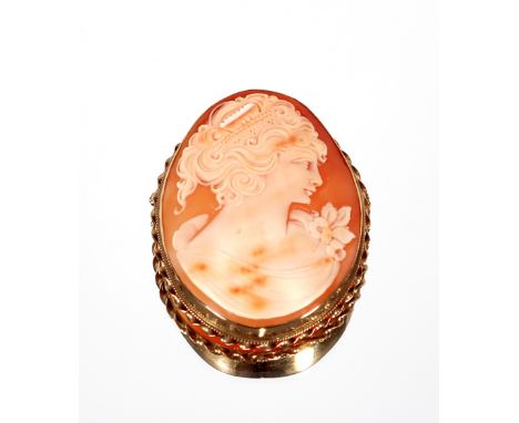 A large oval cameo brooch;&nbsp;a yellow metal enamel and seed pearl decorated oval brooch with memorial panel to the back; a