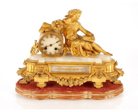 A 19th Century gilt metal and marble mantel clock,&nbsp;decorated with a reclining figure of a classical female scholar, 8 da