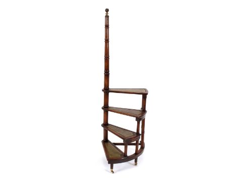 A set of mahogany four tread spiral library steps,&nbsp;having tooled leather inserts, turned tapering hand rail with brass f