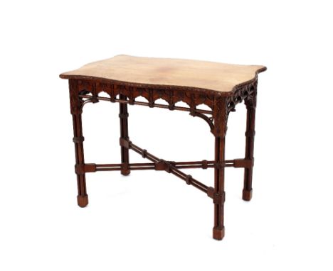 A mahogany Chippendale style side table,&nbsp;the shaped top having carved frieze and raised on cluster column supports and s