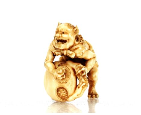 A Chinese ivory Netsuke,&nbsp;in the form of a crouching figure with a large seed pod, bears signature&nbsp;