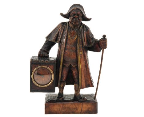 carved wood, depicting Mr. Brumble ( Oliver Twist ), holding a lantern, a clock in the lantern, ca. 1910, height 30 cm.