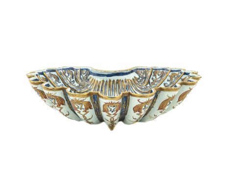 In the form of a shell, decorated in blue and gilt enamels, Kangxi Period, 38 cm. long, chip.