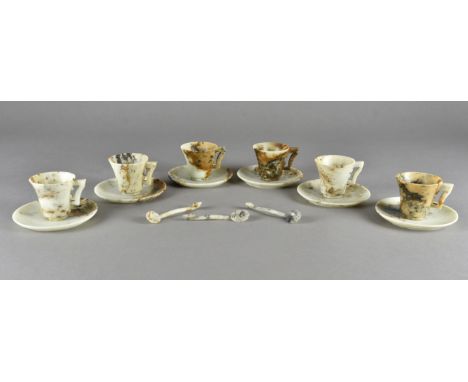 A set of six Chinese carved soapstone coffee cans and saucers, with tapered bodies and angled handles with three spoons carve