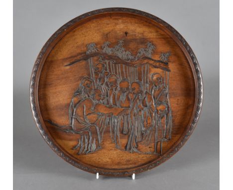 A late 19th Century Chinese hardwood tray, centred with scene of elders reading scroll within a bamboo landscape, 44 cm diame