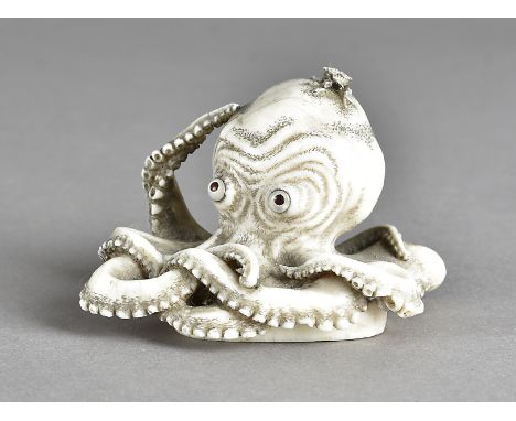 A 19th Century ivory carved octopus, with mother of pearl and tortoiseshell eyes, 8 cm x 5.5 cm x 5 cmHairline cracks in seve