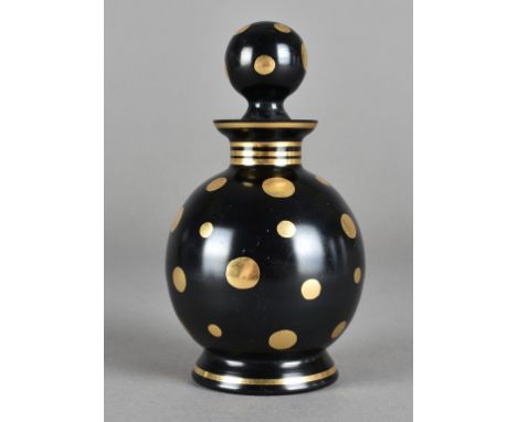 An art deco opaque amethyst glass scent bottle and stopper, heightened with gilt dots, 14 cm high