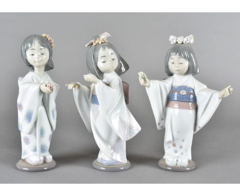 Three Lladro figures of Japanese girls, all dressed in traditional robes, printed marks to base 