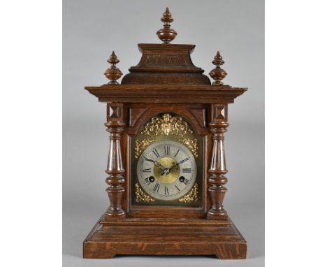 An oak cased eight day mantle clock, brass and steel dial, in architectural case 48 cm high x 30 cm wide x 20 cm deep