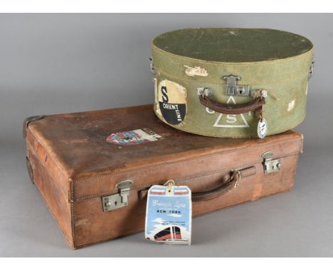 A canvas and leather circular hat box, with chromed fittings and various travel logos together with a dressing table oval eas