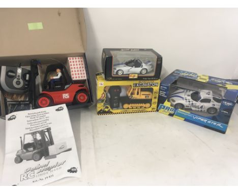 Collection of 3 x toy remote control vehicles including a Dodge Viper..Excavator ( not in original box)..Fork Lift Truck. Als