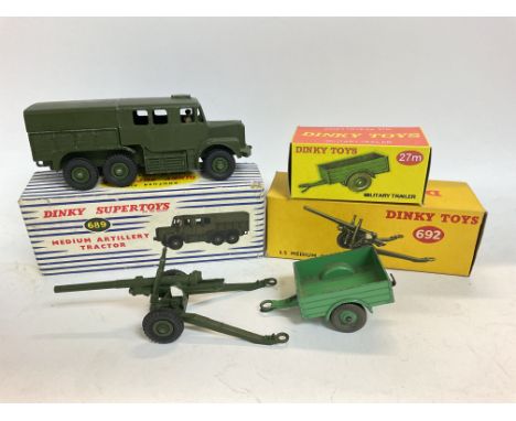 A Boxed Dinky Super Toys Medium Artillery Tractor #689. A 5.5 Medium Gun #692 and a Military Trailer #27M in repro Box.
