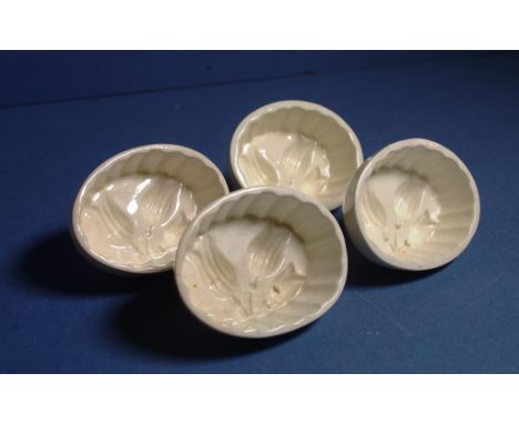 Four Spode antique jelly moulds all with internal impressed tulip pattern. Impressed marks to base, with small glaze chips to