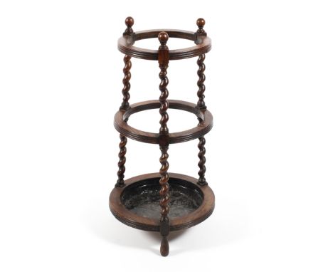 A 19th century oak barley twist stick stand. With three circular reeded apertures, with metal lined base, H75cm 