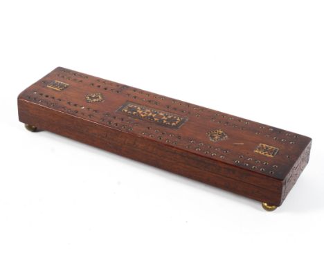 A 19th century mahogany cribbage board. With an extendable arm and counting arm, with inlaid Tunbridge ware and original coun