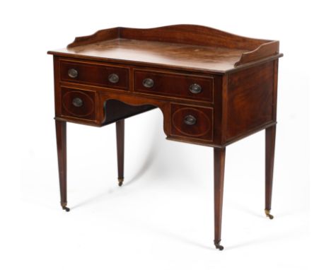 An Edwardian mahogany inlaid ladies kneehole desk. With shaped gallery above two drawers and two cupboard doors, inlaid in bo