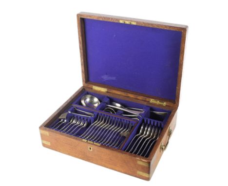 An oak and brass mounted canteen of Maple cutlery. Containing a set of 12 silver-plated spoons, forks, serving spoons, a ladl