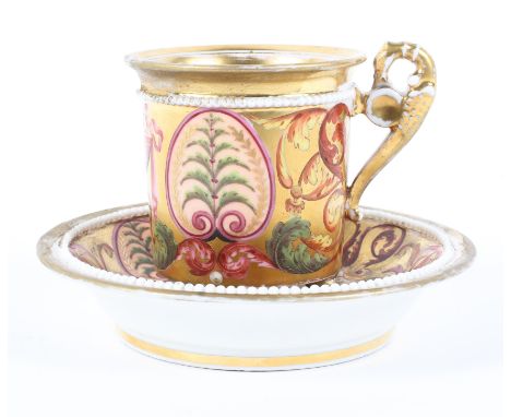 An early 19th century Derby gilt-ground coffee cabinet cup and saucer. With iron-red crossed and crowned D marks, painted wit