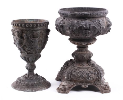 Two Victorian relief cast lead vessels. The first a goblet, cast with high relief cherubs and scrolls, on domed foot, H21.5cm