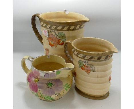 Crown Ducal Graduated Ribbed Jugs: together with Arthur Woods hand decorated similar item, height of tallest 23cm(3) 