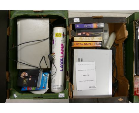 A mixewd collection of items to include: VHS Video Recorders, Tapes, Boxed Lava Lamp etc (2 trays) 