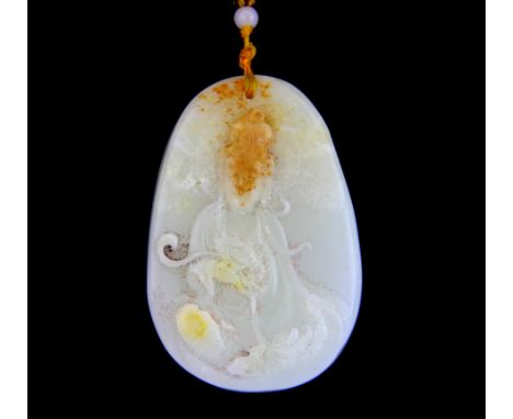 A Chinese carved white and russet jade amulet of the goddess Guanyin on a silk and white jade bead necklace, amulet size 7cm.
