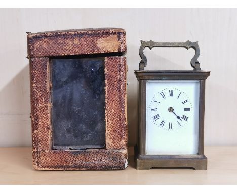 An antique brass carriage clock with carrying case, H. 14cm.