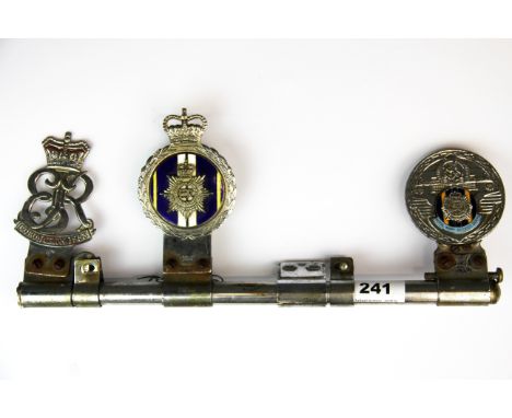 A vintage motorcar badge bar, including 1953 coronation, a Queen Elizabeth II badge and a Royal Army Service Corps badge.