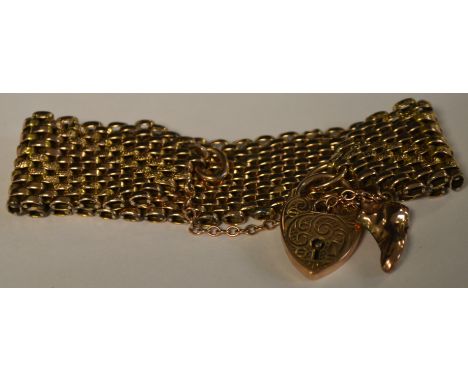 A late 19th/early 20th century yellow metal thirteen row gate bracelet, unmarked, 9ct gold padlock clasp, 32.2g gross