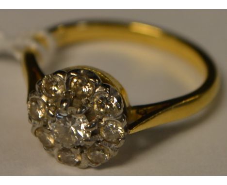 A diamond cluster ring, central round brilliant cut diamond approx 0.45ct, surrounded by a band of eight smaller conforming, 