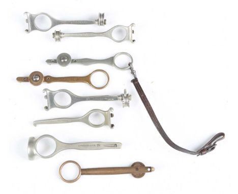A group of eight late 19th/early 20th century nickel plated and brass patent combination cartridge extractor and cleaning too