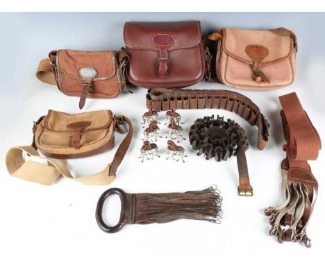 A large collection of 20th century shooting accessories, including cartridge bags, cartridge belts, various pull-throughs and