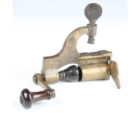 A scarce late 19th century Mellands Registered Patent 1614 cartridge reloading tool with brass body and turned horn and rosew