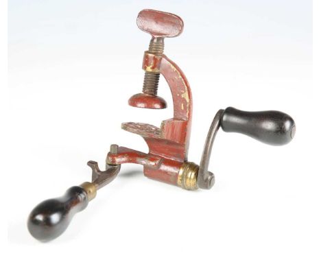 A scarce late 19th century roll turnover .410-bore cartridge reloading tool with red painted body, steel arms and ebonized tu